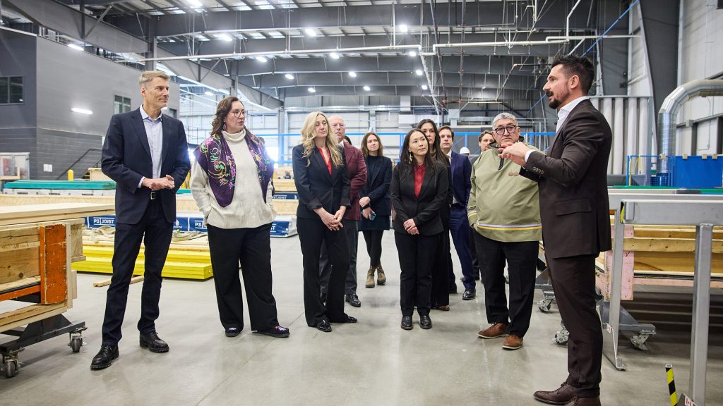 Officials touring the floor of Caivan's manufacturing plant