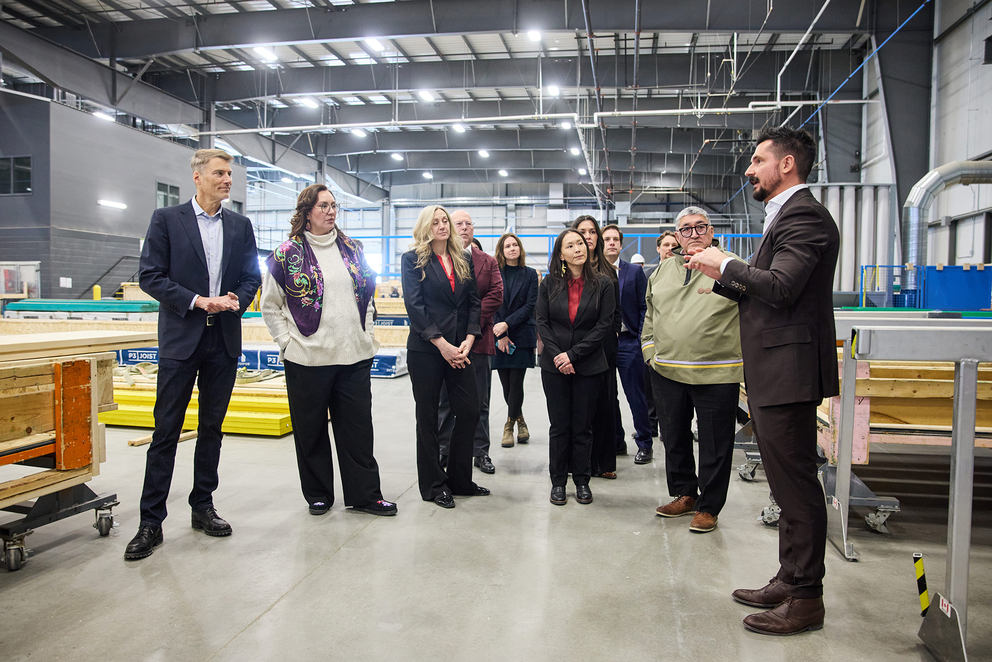 Officials touring the floor of Caivan's manufacturing plant