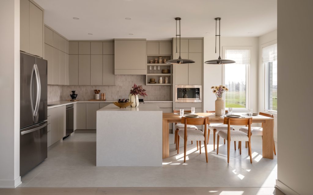 The Hemlock model home, 35' Collection: white kitchen with an island and dining table