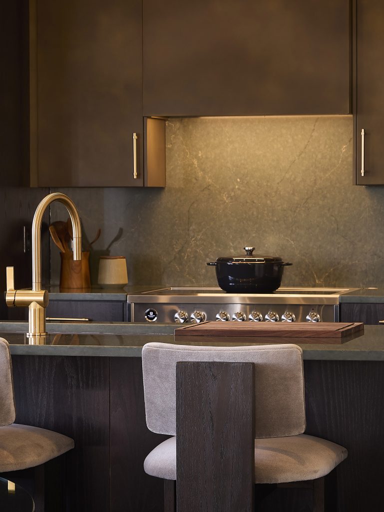 The Stonehaven Loft model home: close view of the kitchen range, brass tap and island stools