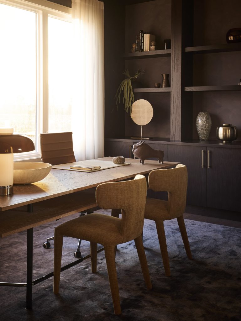 The Stonehaven Loft model home: home office with a wooden desk and built-in shelving