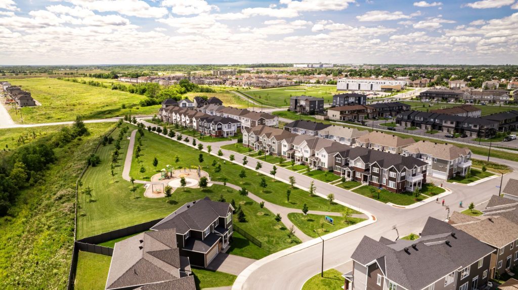 Aerial view of The Conservancy in Barrhaven, with streets of homes beside open fields