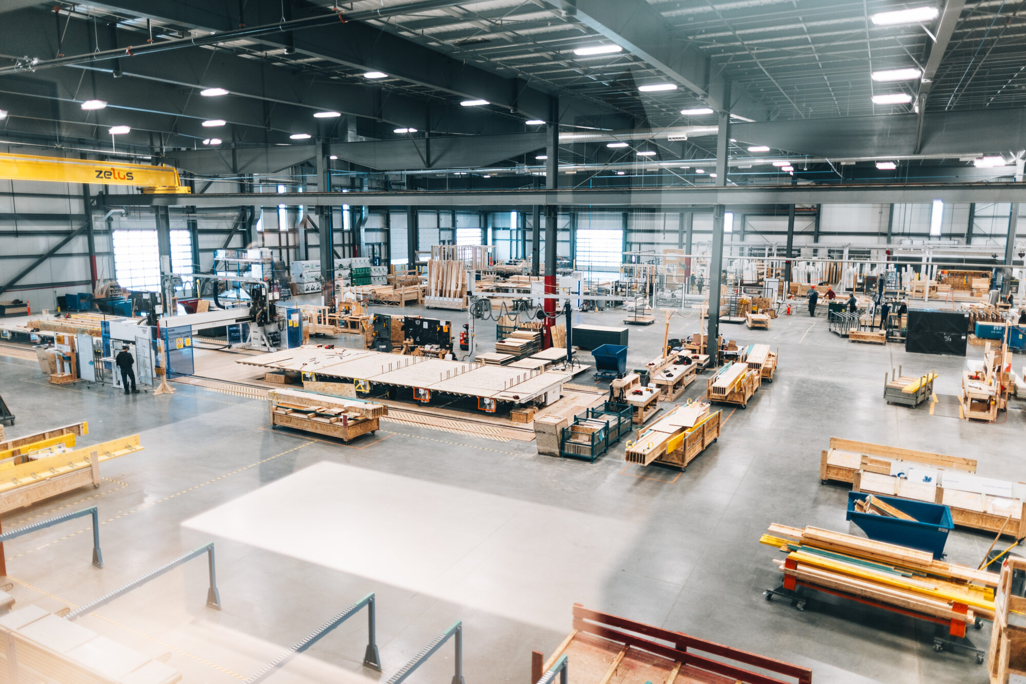 Caivan's manufacturing plant, with assembly lines and stacked timber
