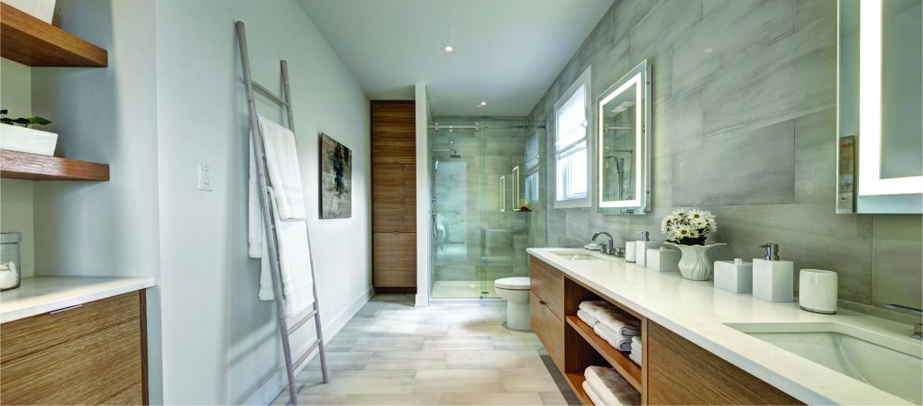 Series II Plan 2 model home: bathroom with a twin vanity, glass shower and green tiling