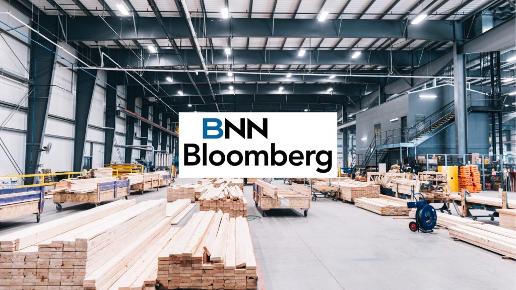 The BNN Bloomberg logo over Caivan's factory floor and stacked lumber
