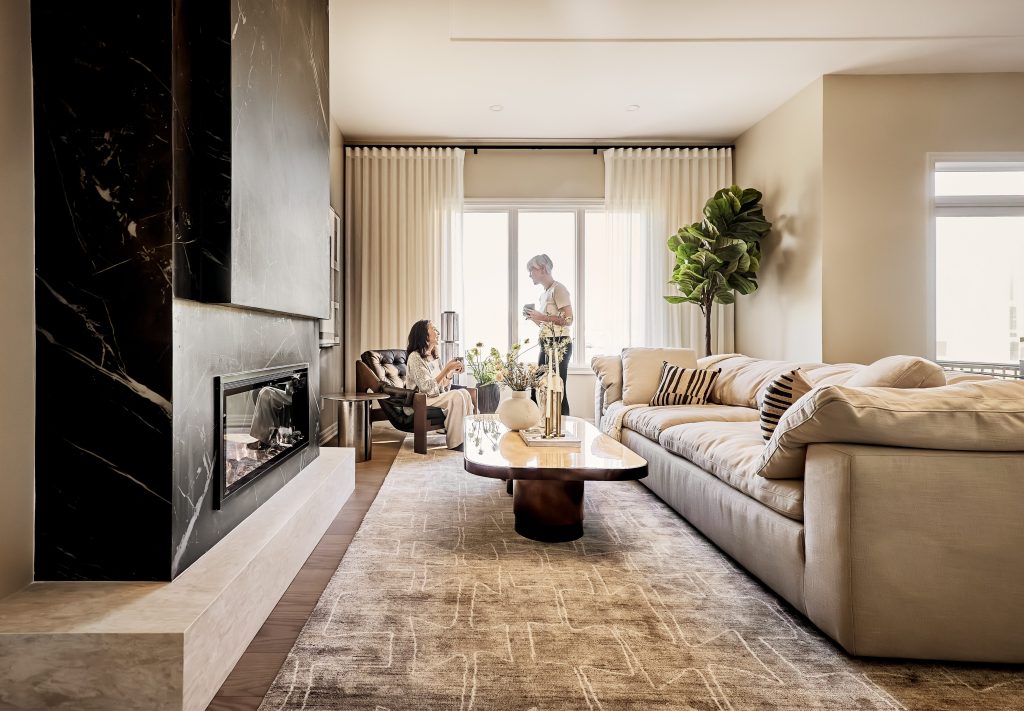 The Ironridge model home: living room with a black marble fireplace and a long sectional sofa