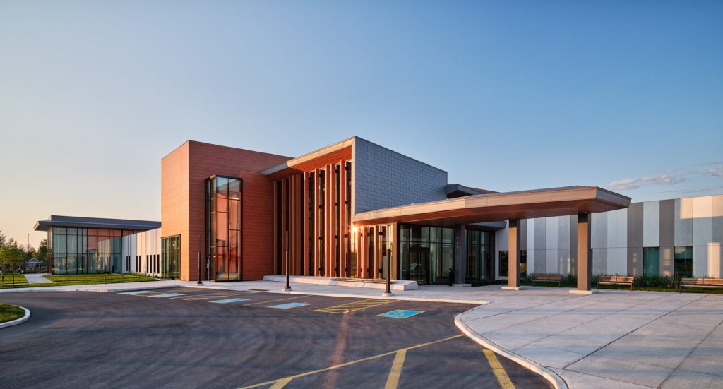 The Orléans Health Hub building at dusk, in brick and glass