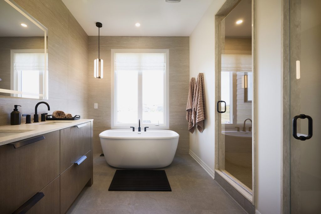 The Ironridge model home: bathroom with a freestanding tub between a vanity and a glass shower
