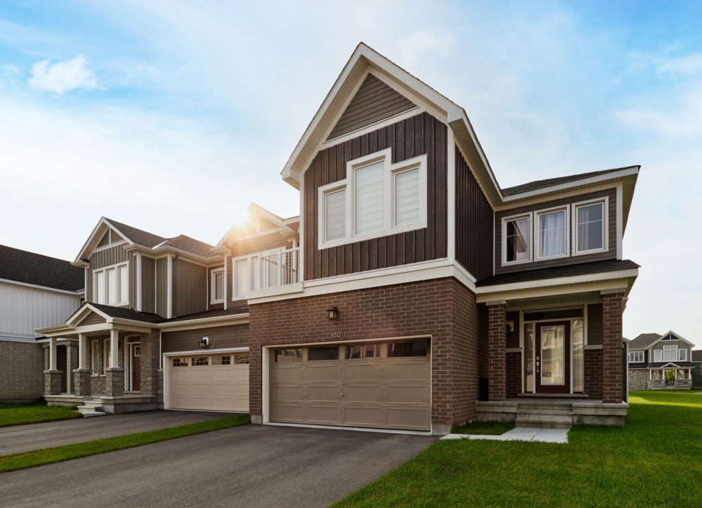 A move-in ready Fox Run home in brick and grey siding, with a double garage