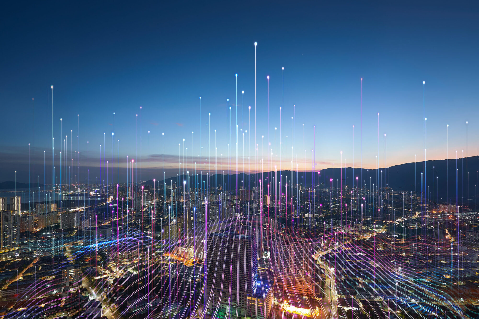 A city skyline at dusk, overlaid with points of light