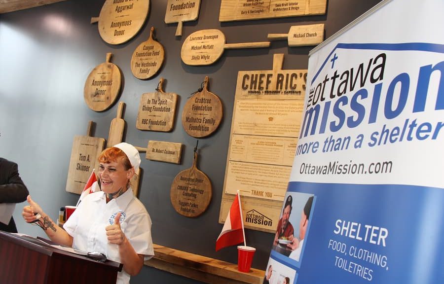 A volunteer in chef's whites at the Ottawa Mission's kitchen counter