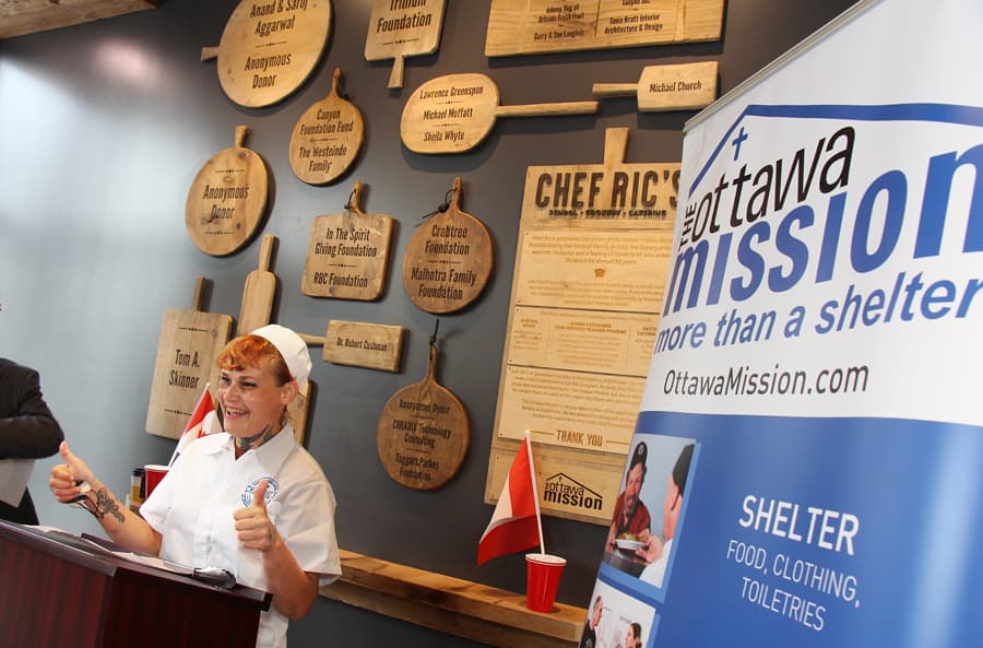 A volunteer in chef's whites at the Ottawa Mission's kitchen counter