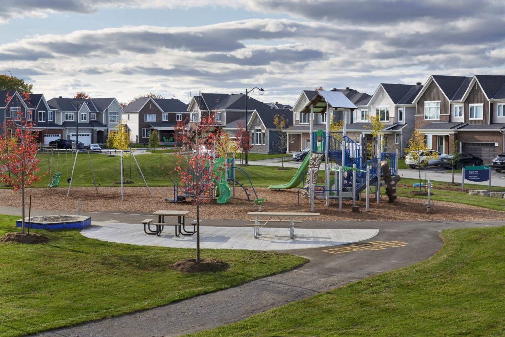 A playground at Orléans Village, with a street of finished homes behind