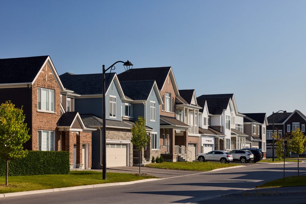 Street of finished Orléans Village homes in brick with attached garages