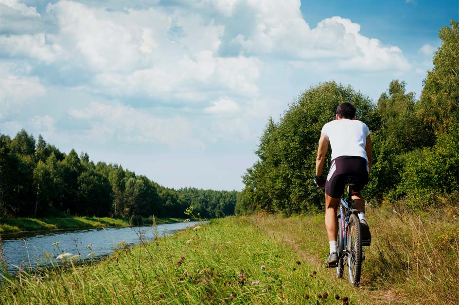 A cyclist riding a trail beside Bronte Creek