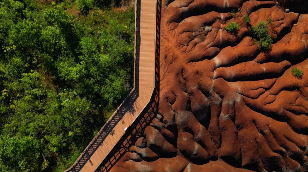 Aerial view of the red rock ridges of the Cheltenham Badlands
