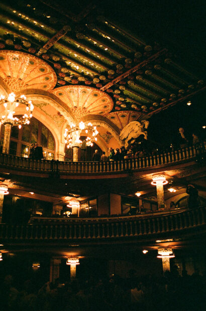 The gilded interior of a theatre, seen from the upper circle