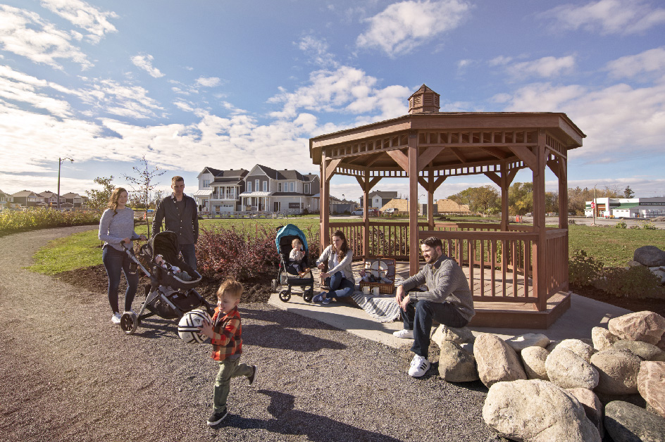 Families gathered at a gazebo on a path at Fox Run