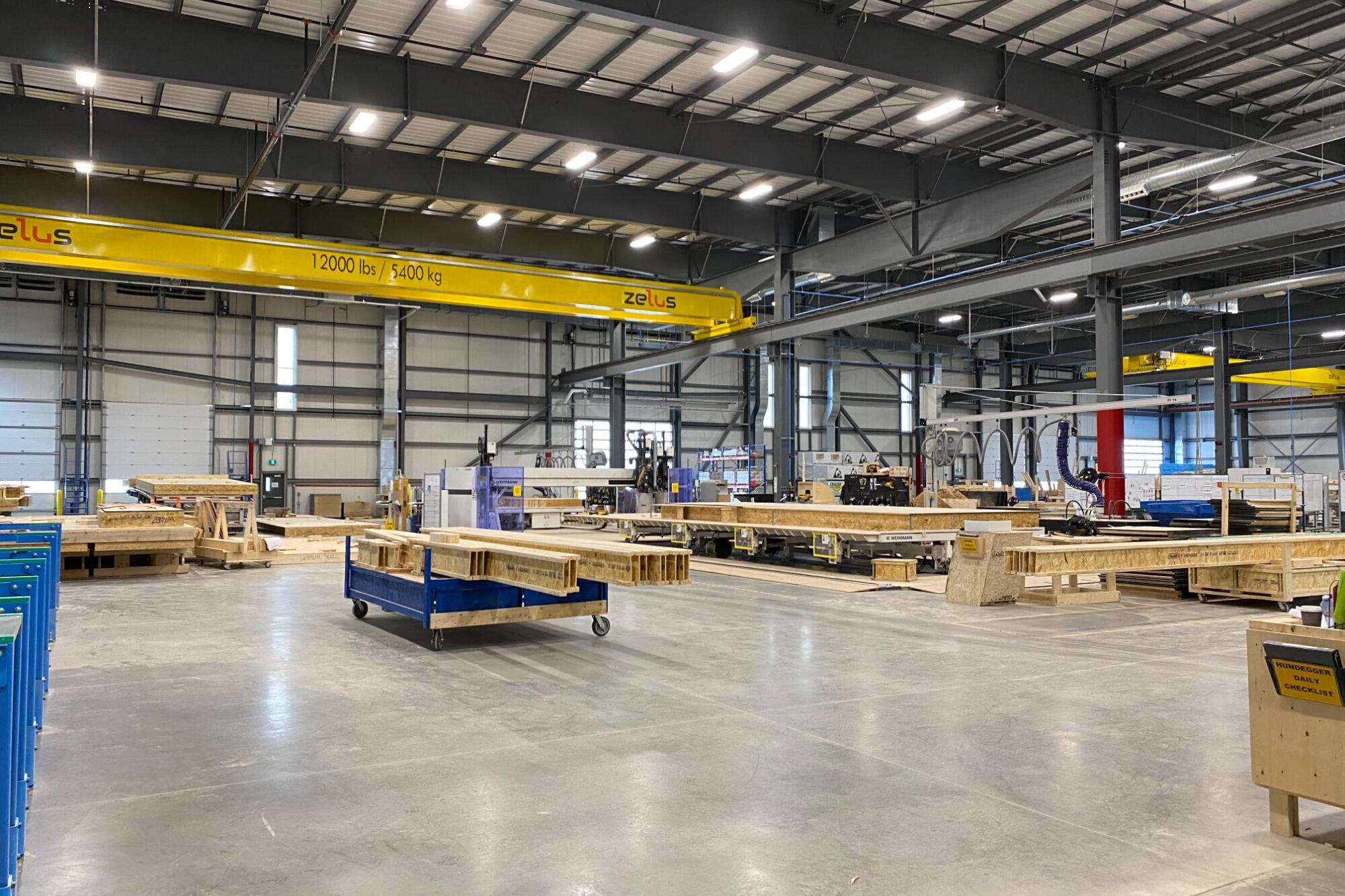 Caivan's manufacturing plant, with overhead cranes and timber assembly lines