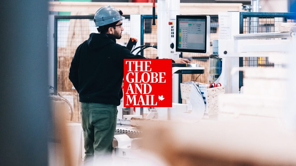 A worker at a factory control panel, beside The Globe and Mail masthead