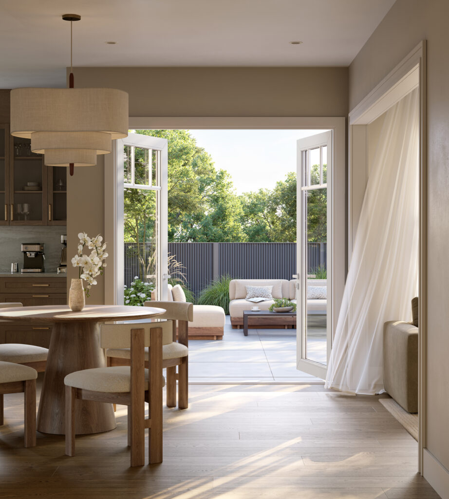 Breakfast area at Five Oaks, with a round dining table and French doors open to the backyard