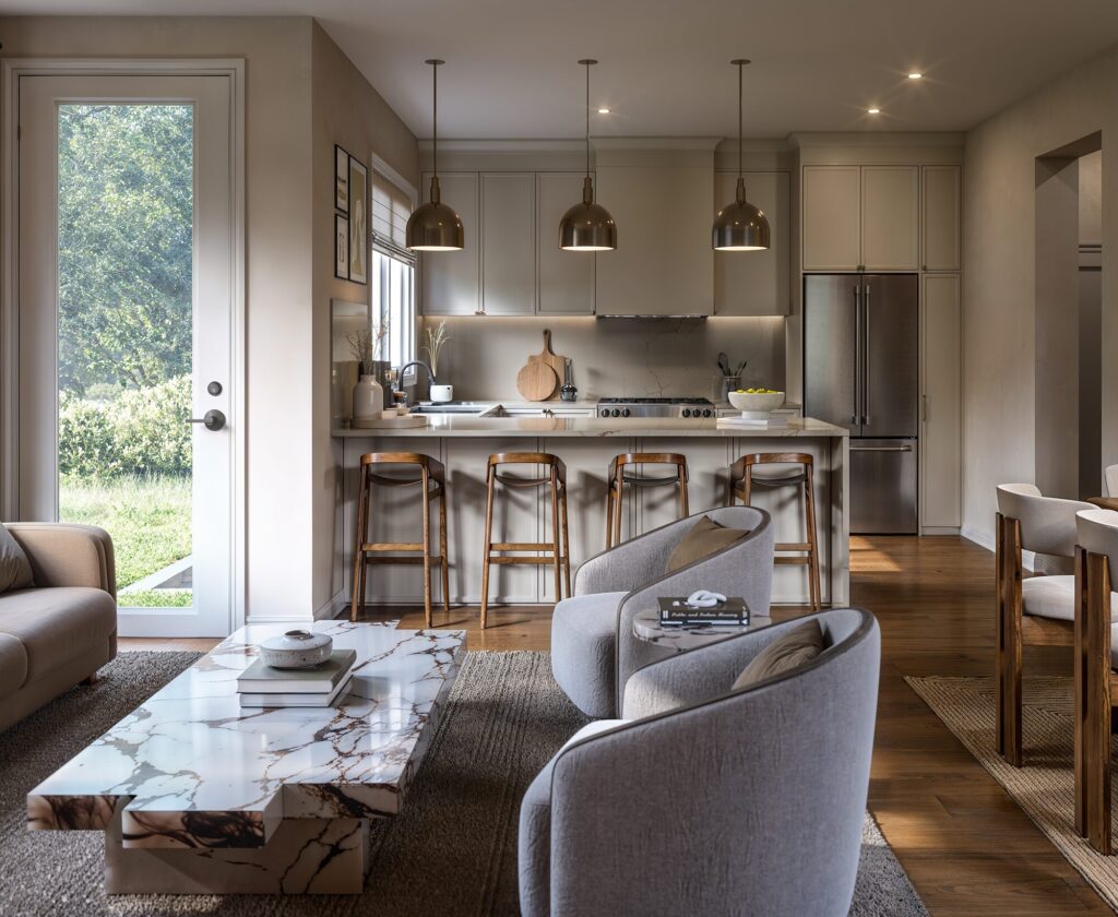 Kitchen in a 24′ townhome at The Ridge, with an island and bar stools open to the living room