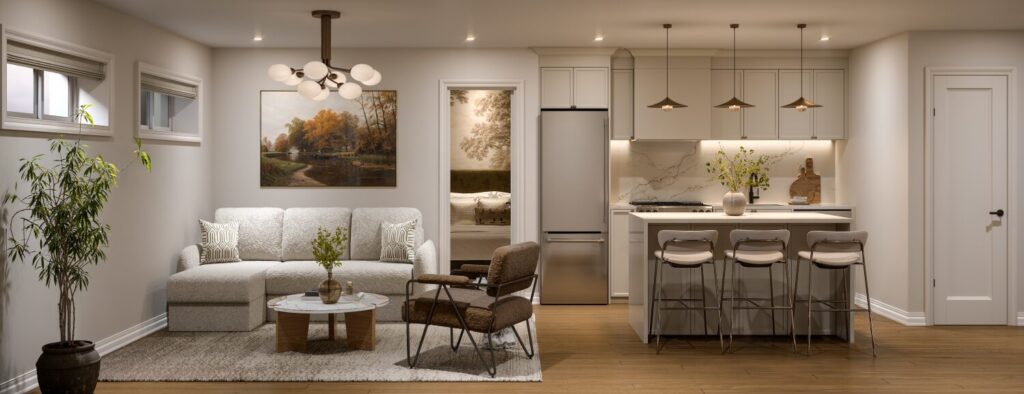 Basement secondary suite in a 24′ townhome at The Ridge, with a living area and a kitchen island